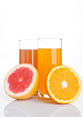 Glasses of healthy grapefruit  and orange juice on white background