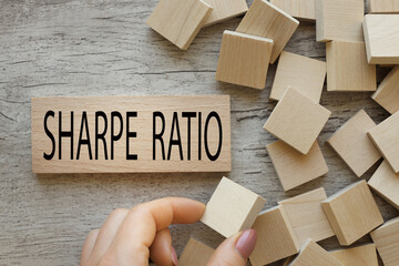 top view of a wooden block with text in black font. word SHARPE RATIO