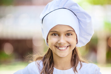 Smiling girl in a chef's hat