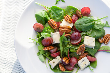 Fresh salad with cheese, grapes and nuts.