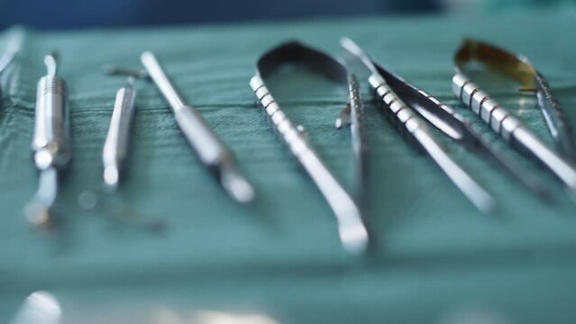 Shot of dentist tools on a green background. Forceps curved, explorer curved, dental explorer angular. Hygiene. Health