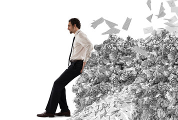 Businessman pushing with fatigue a big pile of paperwork