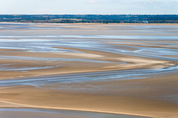 Sea coast at low tide. The tides can vary greatly, at roughly 14m between high and low water marks. One of France's most recognizable landmarks. View from the top of the mount Saint Michael's, France