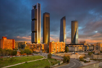 Image of Madrid, Spain financial district with modern skyscrapers during sunrise.
