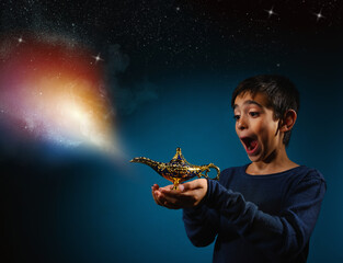 Amazed child with magic Aladin lamp in hand