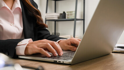 Busineswoman working in office using laptop.