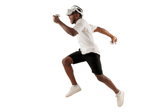 african american male athlete runs forward and plays in virtual reality glasses on white isolated background