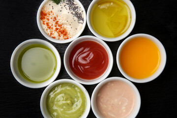 Different sauces and dips in bowls on the restaurant table
