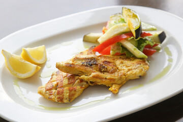 Grilled chicken with grilled vegetables served on the restaurant table	