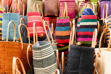 Colorful handcrafted straw baskets sold at a farmers market in Lourmarin, Provence, France