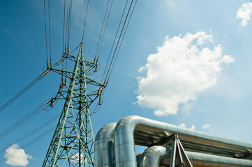 pipeline and power lines against the background of blue sky and clouds