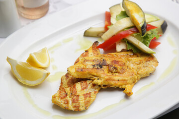 Grilled chicken with grilled vegetables served on the restaurant table
