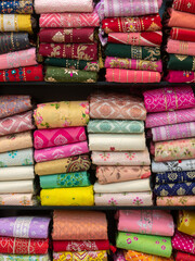 Colorful indian female cloths stack in wholesale shop