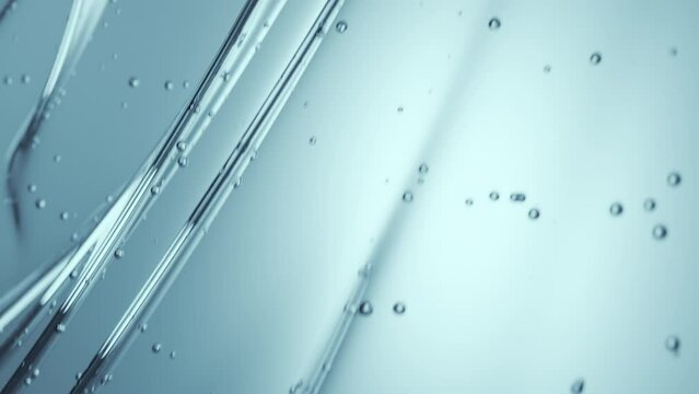 Glycerin gel flow texture. Blue serum toner. Liquid gel moisturizer with bubbles macro. Clear cosmetic cream or face serum. Abstract background for cosmetics commercial product