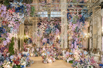 The wedding stage is decorated with fairy tale themed flowers.