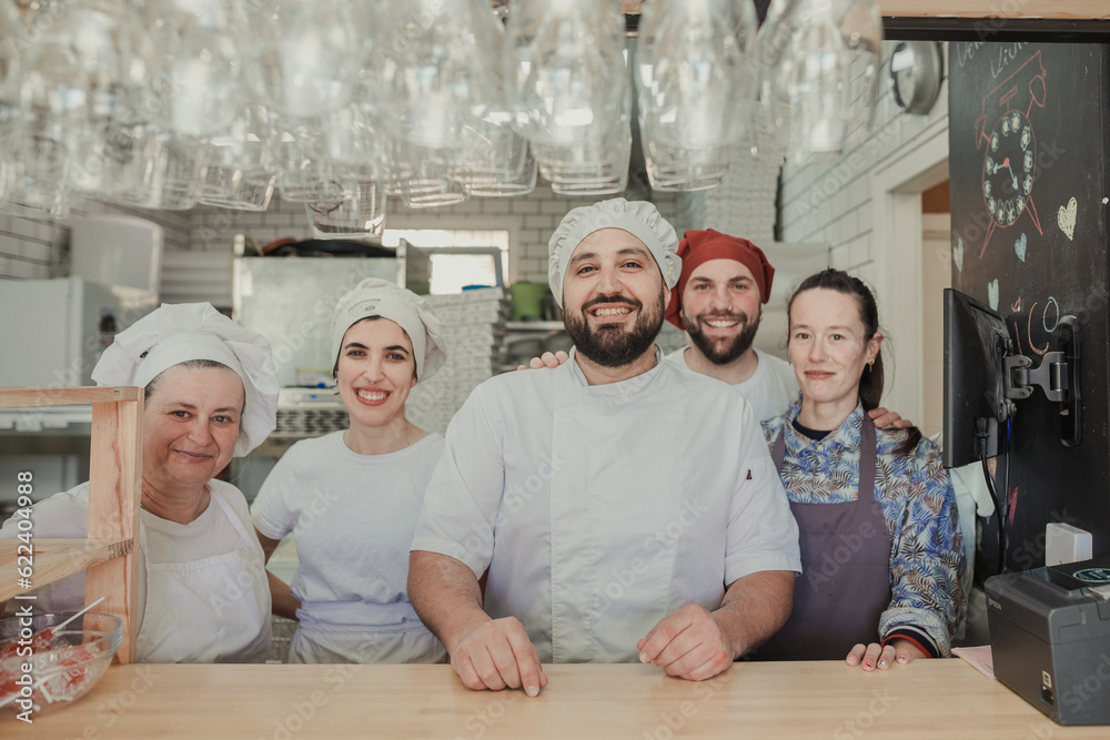 Wall mural Friendly team work of a pizzeria restaurant