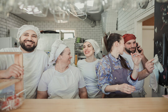Portrait of the staff members of a pizzeria restaurant