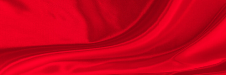 Black red satin dark fabric texture luxurious shiny that is abstract silk cloth background with patterns soft waves blur beautiful.