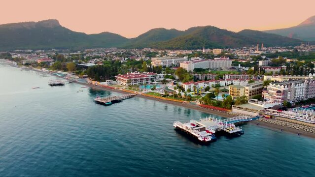 beauty of Kemer from a new perspective with breathtaking aerial view, showcasing a stunning panorama of hotels nestled amidst the scenic mountain landscape.