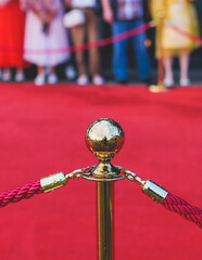 Red carpet with ropes and golden barriers on a luxury party entrance, cinema premiere film festival...
