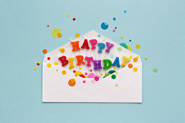 Birthday card envelope with happy birthday candles and celebration confetti