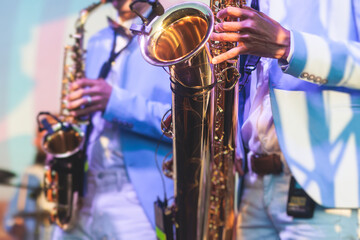 Concert view of saxophonist in a blue and white suit, a saxophone sax player with vocalist and...