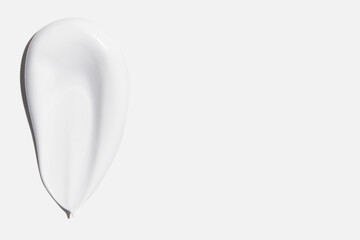 A smear of cream on a white background