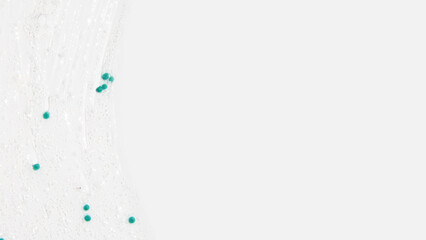 Transparent gel with blue granules smeared serum on a white background