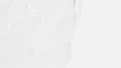 White cosmetic cream smeared on a white background