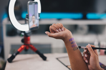 unrecognized woman influencer applying makeup at home. woman vlogger applying makeup