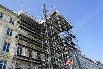 Restoration of the facade of a historic house using scaffolding with temporary elevator