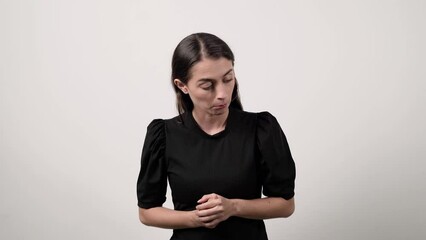 Woman in a black shirt analyzes and pokes around with a joking face, on a white background - Powered by Adobe