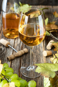 Dry wine and  ripe grape on wooden tablea