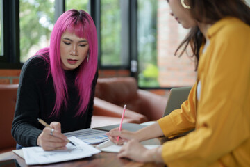 Asian transgender Pink Hair Business People Meeting Design Ideas for new start up project working together meeting business plan listen coworker and discussing team work Gender equality LGBTQ+ concept