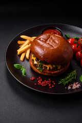 Burger with juicy beef cutlet, cheese, tomatoes, salt, spices and herbs