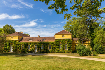 Fototapeta na wymiar Sanssouci palace and park in spring, in Potsdam, Brandenburg, Germany. A beautiful green facade