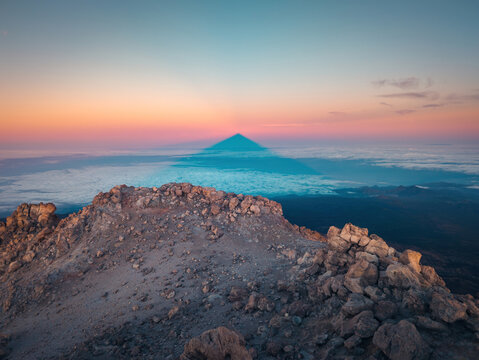 Amazing view of volcanic terrain with rocks and sunset cloudy sky in evening