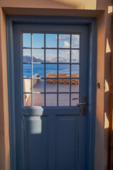 Wooden Blue Door Entrance to a Traditional House - Oia Village, Santorini Island, Greece - Travel Destination, Summer, Sunset