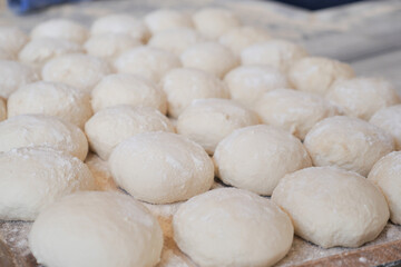 Fototapeta na wymiar fresh raw dough for bread or pizza .