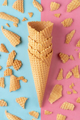 Ice cream waffle cones on pink and blue background