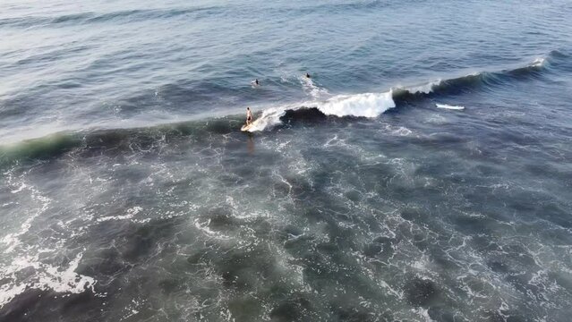 El Paredon, a charming coastal surfer village, enjoys sunlight. Rustic huts, black sands and amazing waves. A slice of tropical paradise on the shore of the Pacific Ocean in Guatemala.