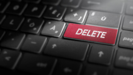 Delete key on laptop computer keyboard, red button on the dark grey keybord of a modern laptop notebook, technology concept for data deletion and removal, close-up