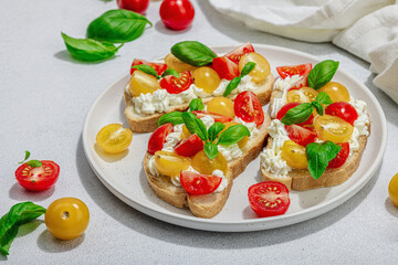 Fresh bread sandwiches with tomato cherry, cream cheese and basil leaves. Morning breakfast concept