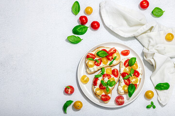 Fresh bread sandwiches with tomato cherry, cream cheese and basil leaves. Morning breakfast concept