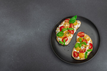 Fresh bread sandwiches with tomato cherry, cream cheese and basil leaves. Morning breakfast concept