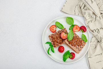 Delicious chocolate cakes with fresh strawberries. Sweet dessert, good morning concept