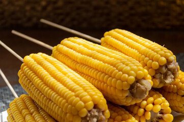 Boiled sweet corn on bamboo sticks