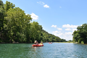 Fototapeta na wymiar People in a Raft on a River