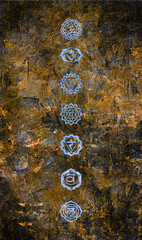 Rough motley background on a stone wall with the symbols of the seven chakras, black, brown, blue, spiritual healing