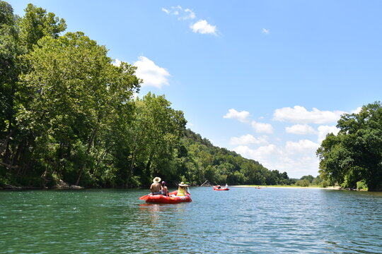 People in a Raft on a River